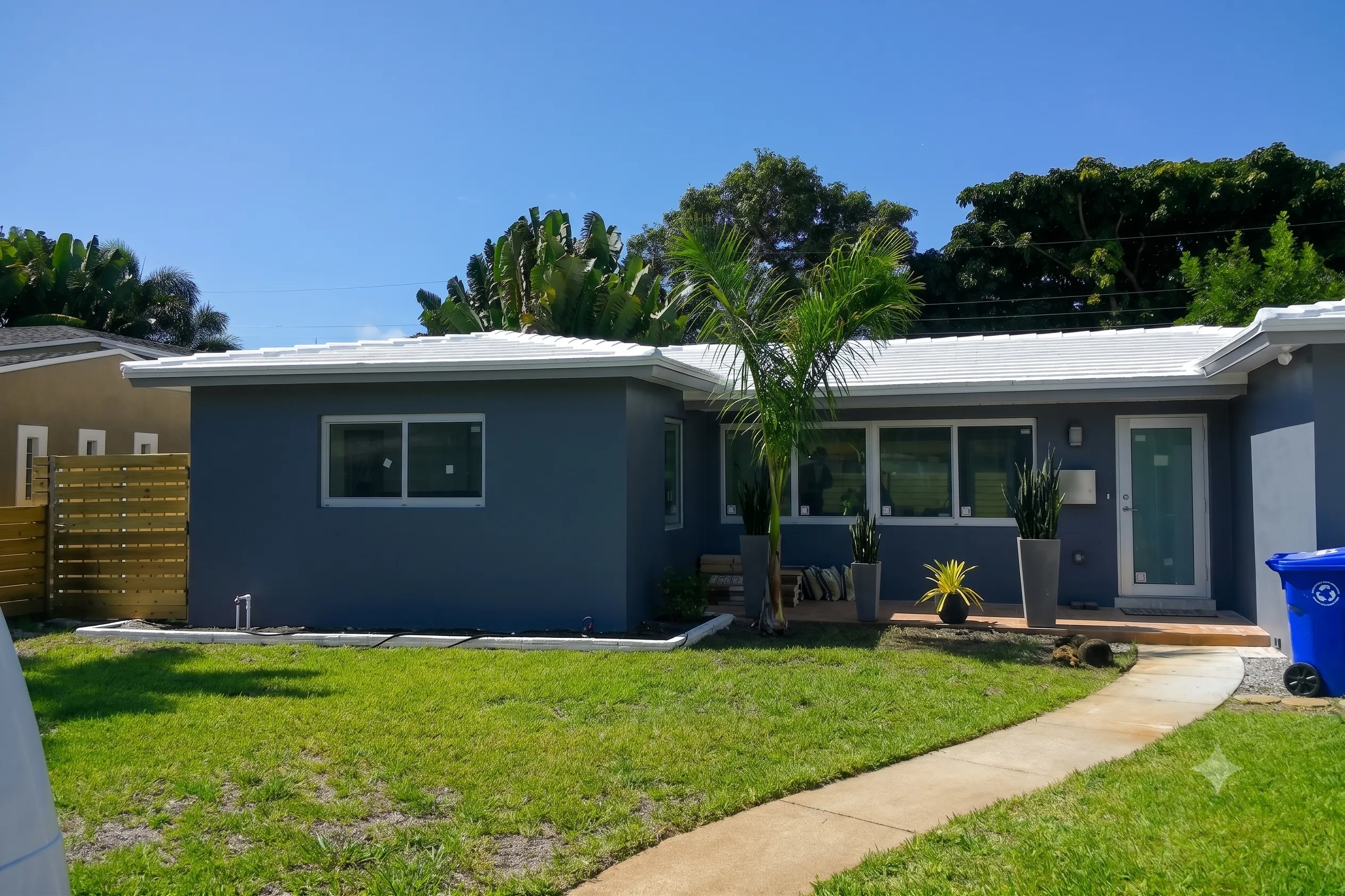 Full exterior house repaint in modern slate gray with crisp white trim